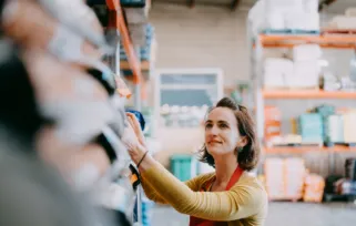 woman in apron stocking shelves