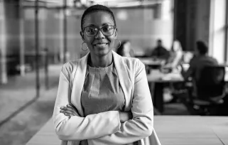 woman standing in office with arms crossed