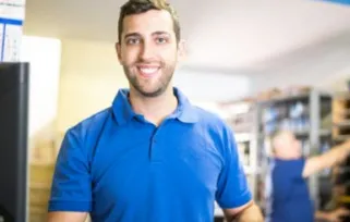 young man using computer working in a store
