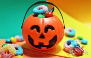 jack-o-lantern bucket with halloween candy overflowing