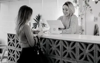 concierge helping client at desk