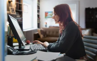 woman sitting at desk on computer
