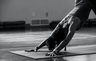yoga teacher doing downward facing dog pose