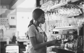 A barista using an espresso machine
