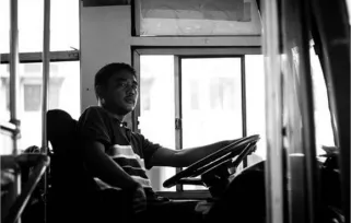 a bus driver sitting in the driving seat