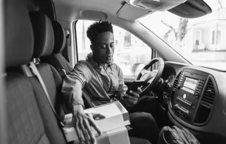 package handler with boxes in van