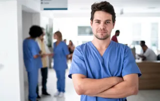 male nurse in blue scrubs in a hospital