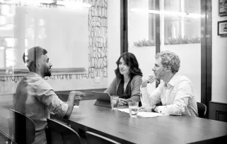 man in an interview with two interviewers across the desk