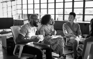 group of co-workers in office laughing