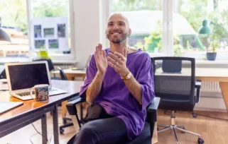 Man clapping hands in office