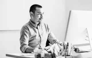 Man At%20desk On%20computer WritingB%26W Jpg