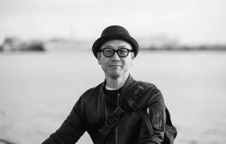 man in glasses and hat outdoors