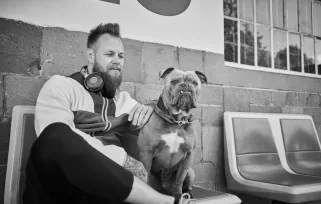 dogwalker sitting with dog