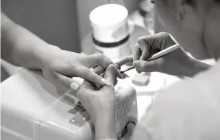 nail technician giving a client a manicure