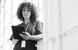 nurse wearing stethoscope using tablet