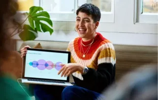woman smiling with a laptop