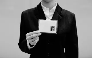 woman holding security pass to the camera