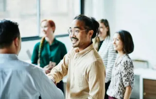 a group of people are having a discussion in meeting room