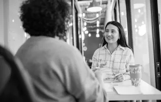 two women having a meeting across a desk