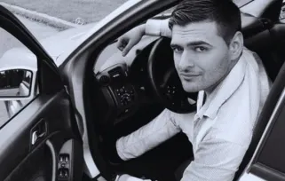 car driver with driver's door open