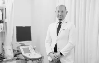 ultrasound technician standing with machine