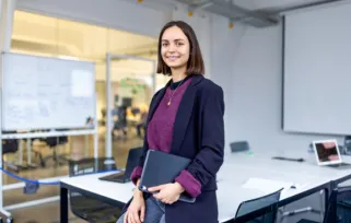 Woman%20in%20office%20holding%20computer Png