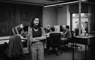 woman with arms crossed standing in office