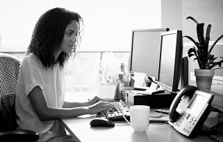 Woman At%20desk On%20computer With%20mug%20of%20coffeeB%26W Jpg