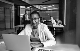 woman sitting at laptop in office