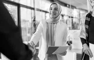 woman shaking hands with someone in an office