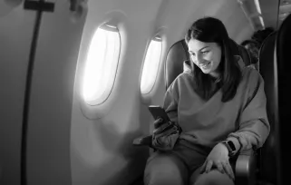 Woman Traveling On%20plane Looking%20at%20phoneB%26W Png