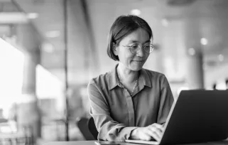 medical office manager typing on laptop