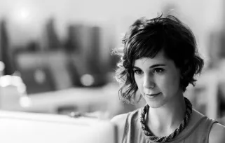 woman sitting at apple computer