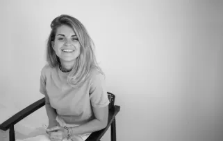 woman sitting smiling at the camera