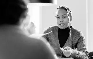 woman handing a resume across an interview table