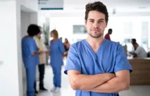 male nurse in blue scrubs in a hospital