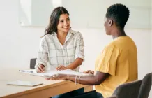 two people in a job interview sitting at a desk