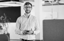 man_in glasses_looking at camera_on phone