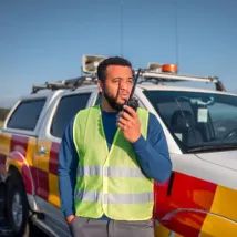 man with walkie talkie on his hands reporting the status while patrolling the border