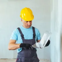 Man spackling new drywall or plasterboard