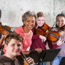 Teacher teaching music lesson to children