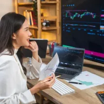 young woman analyze the market using PC and laptop in office